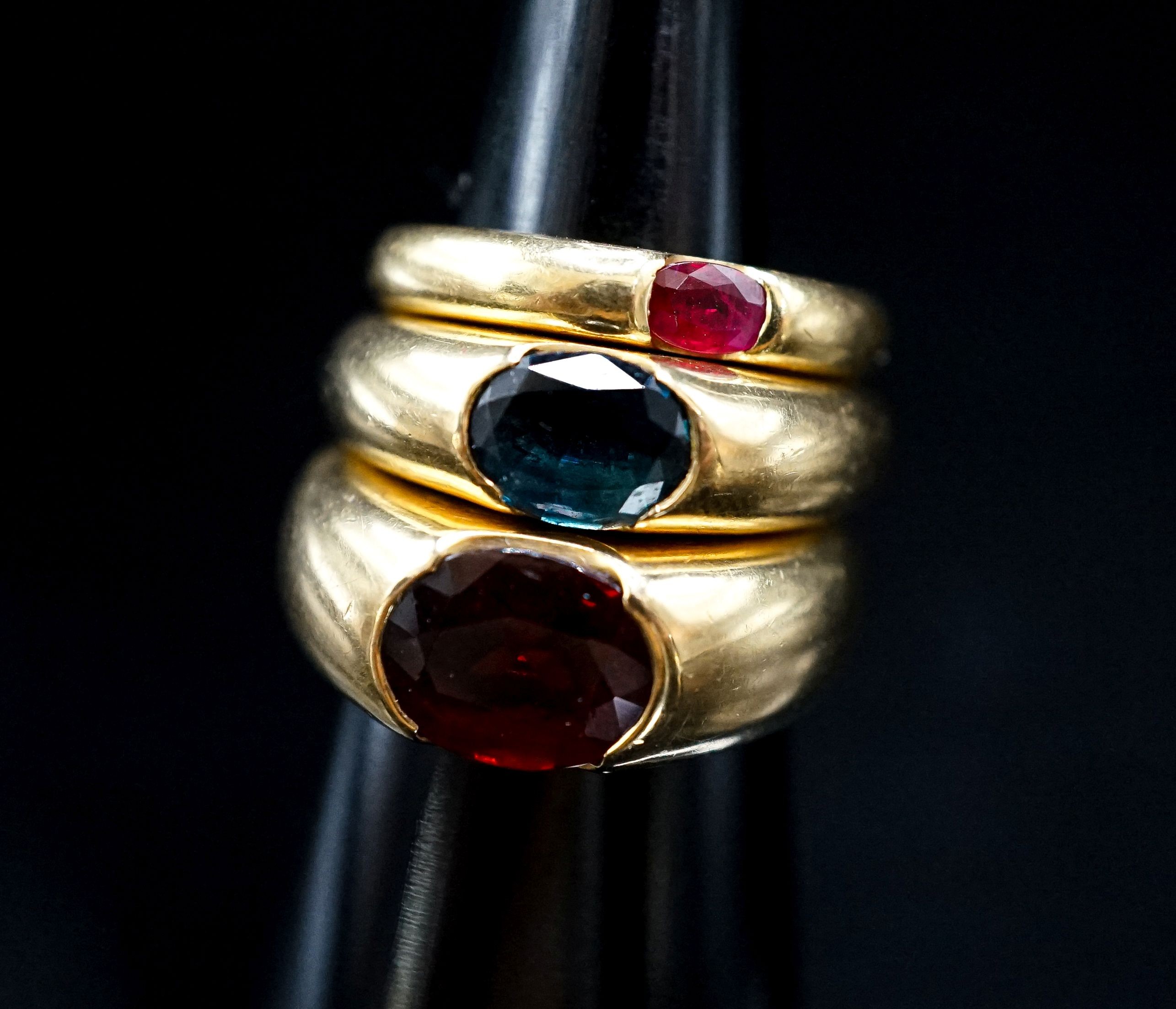 Two 18ct and gypsy set gem set rings, maker TR, size M and a similar smaller ring, size H, gross weight 20 grams.